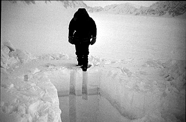 A deep snow pit dug into a glacier.