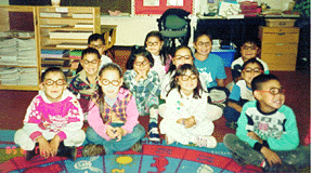 Time for E.S.L.! First Grade students wear glasses when they speak English.