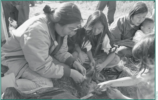 Nora David, Lorna David, Angel Joseph, Jeanette John & baby D'anjelo clean moose stomach at Batzulnetas, '99.