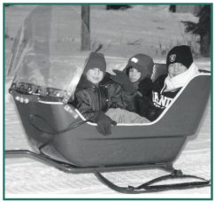Douglas Neal, Derrick Neal and Freddy Nicolai, Jr. enjoy a sled ride.