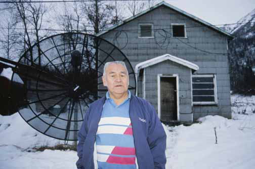 Joe Hotch stands in front of the Bear House in Klukwan.