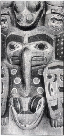 At the bottom of the totem a crane holds a frog figure.