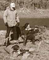 Richard teaches Charlotte and Maxine how to handle rifles